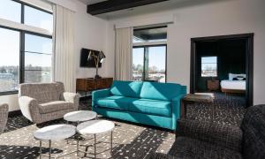 a living room with a blue couch and chairs at The Earl in Charlevoix in Charlevoix