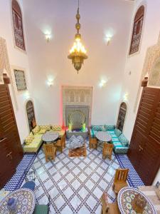 a living room with a couch and a fireplace at Riad Fes Colors & Spa in Fès