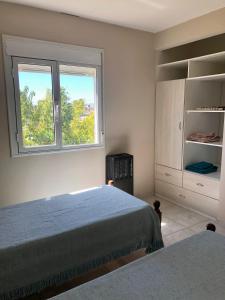 a bedroom with two beds and a window at Duplex Boulevard in Viedma