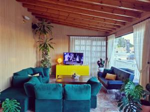 a living room with blue couches and a tv at Hotel Venta El Puerto in Murcia