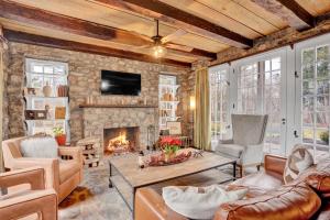 a living room with a stone wall and a fireplace at Chimney Hill Estate Inn in Lambertville