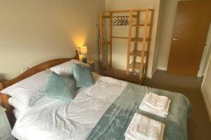 a bedroom with a bed with two towels on it at Lovely 2 bedroom apartment in Kendal town centre in Kendal
