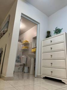 - une chambre avec une commode blanche et un miroir dans l'établissement Playa y Campo Studio, à Isabela