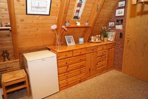 a kitchen with a white refrigerator and a counter at Zeltdachhaus mit W_LAN _ 2 x TV in Damp