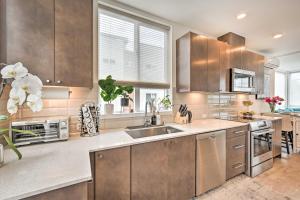 a kitchen with stainless steel cabinets and a sink at NEW! Stylish Townhome in Ballard in Seattle