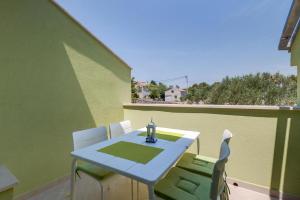 a table and chairs on the balcony of a house at Laguna in Nerezine