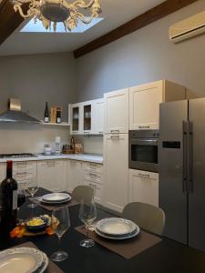 a kitchen with a table with plates and wine glasses at Antica Dimora in Levico Terme +40 photos