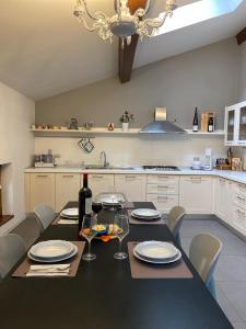 una cucina con tavolo nero e bicchieri di vino di Antica Dimora a Levico Terme