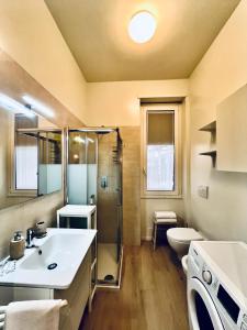 a bathroom with a sink and a shower and a toilet at Corso Lodi Apartment in Milan