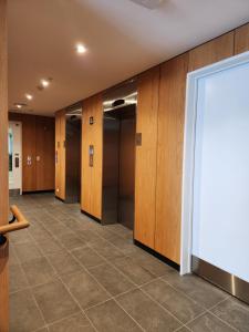 a row of lockers in a hallway at Stay Max Apartment for Perfect Short Stay in Auckland