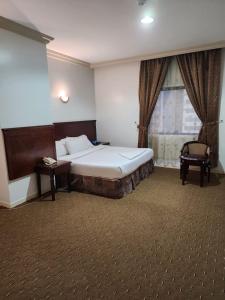 En eller flere senge i et værelse på فندق مسارات المشاعر