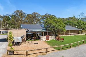 a house with a fence in front of it at Fentons Run High Range in Joadja Creek