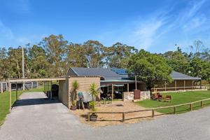 a house with a fence in front of it at Fentons Run High Range in Joadja Creek