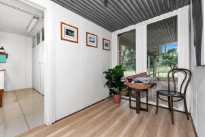 a living room with a table and a chair at Fentons Run High Range in Joadja Creek