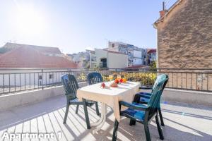 a table and four chairs on a balcony at Valentina Apartments Vodice in Vodice