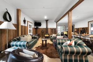 a living room with couches and a table at Fentons Run High Range in Joadja Creek