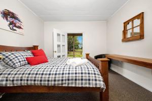 a bedroom with a bed with red pillows at Fentons Run High Range in Joadja Creek