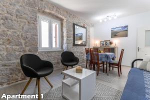 ein Wohnzimmer mit einer Steinmauer in der Unterkunft Valentina Apartments Vodice in Vodice