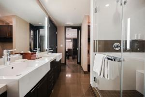 a bathroom with two sinks and a shower at StripViewSuites at Vdara in Las Vegas