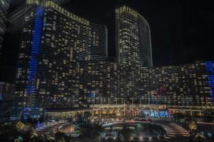 a view of a large building at night at StripViewSuites at Vdara in Las Vegas