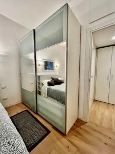 a bedroom with a glass partition with a bed in it at Corso Lodi Apartment in Milan