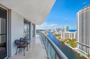 a balcony with two chairs and a view of a river at BeachWalk Resort - VIP TOWER #2802 - OCEANVIEW UNIT 3 BEDROOM & 3 BATHROOM in Hallandale Beach