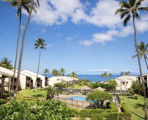 a view of the resort with palm trees and a swimming pool at Hale Kamaole 158 in Wailea