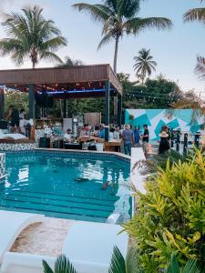 a pool at a resort with palm trees in the background at Aqua Marina Beach Club in Rincon