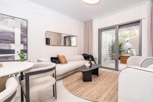 a living room with a couch and a table at Lovely 1 bedroom apt w/pool. Haneviim st jerusalem in Jerusalem
