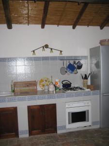 a kitchen with a stove and a counter top at La casa del Cavaliere in Santa Maria di Licodia