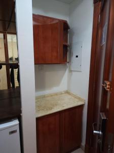 a kitchen with wooden cabinets and a counter top at فندق مسارات المشاعر in Makkah