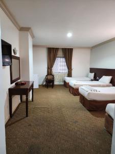 En eller flere senge i et værelse på فندق مسارات المشاعر