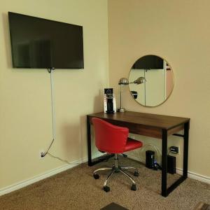 a desk with a red chair and a mirror at Camp Kingsbury- SEAWORLD and MEDICAL Center Best LOCATION in San Antonio