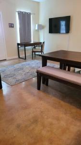 a living room with two tables and a tv at Camp Kingsbury- SEAWORLD and MEDICAL Center Best LOCATION in San Antonio