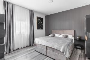 a bedroom with a bed and a large window at Luxury room Ekstaza in Solin