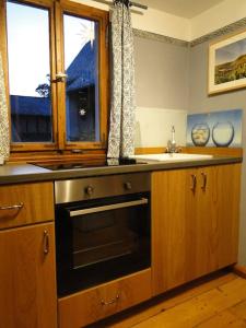 a kitchen with a stove and a sink at Kleine Residenz am Zehnthof in Senheim