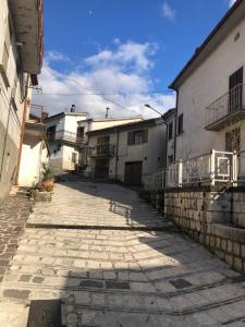an empty alley with buildings and a blue sky at Lucy Home in Forlì del Sannio