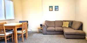 a living room with a couch and a table at Heritage House Apartments in Swindon +24 photos