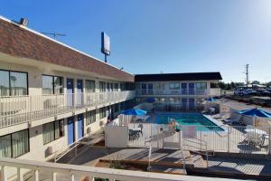 arial view of a hotel with a pool and a building at Motel 6-San Angelo, TX in San Angelo