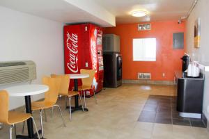 a kitchen with a cocacola sodaacistacistacistacistacist at Motel 6-Goodland, KS in Goodland