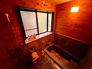 an overhead view of a bathroom with a toilet and a window at 湯布院 星の里 Yufuin Hoshinosato in Yufuin