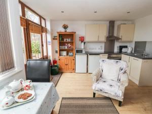 a kitchen with a table and a chair at Nuthatch in Ivegill