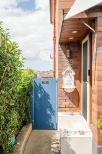 a blue door on the side of a house at Sky Home - Two Bedroom Loft Townhouse with Bay Views in Sydney