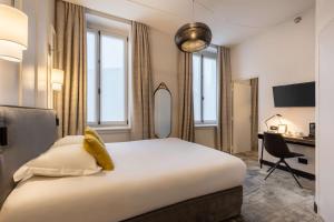 a hotel room with a large bed and a desk at Best Western Urban Hotel in Lille +68 photos