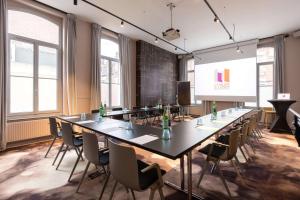 a conference room with a long table and chairs at Best Western Urban Hotel in Lille