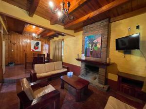 a living room with a couch and a fireplace at Cabañas Lupita in Mazamitla