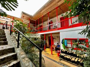 a person sitting on a bench in front of a building at Hostal Tralala Salento in Salento