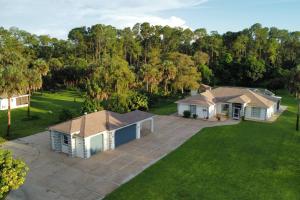 an aerial view of a house with a yard at Private Finca on 2 Acres with Pool in Naples
