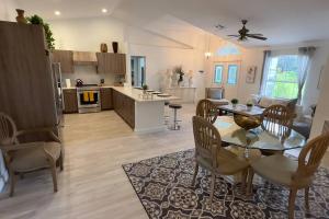 a kitchen and living room with a table and chairs at Private Finca on 2 Acres with Pool in Naples