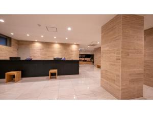 an empty lobby with a reception desk and benches at Hotel Best Price Kochi - Vacation STAY 17542v in Kochi